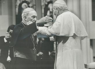 Papal embrace, Emmett Cardinal Carter and Pope John Paul II embrace inside St