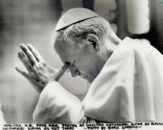 Solemn moment, Pope John Paul II prays yesterday at Our Lady of Assumption Cathedral in Moncton, where he praised Acadians for preserving their Catholic faith in the face of many difficulties