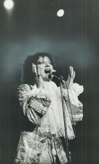 A raven-haired Louis XIV, Carole Pope, winner of the 1984 Juno Award for female vocalist of the year, shed black leather for lace and brocade at Rough Trade's concert in Massey Hall