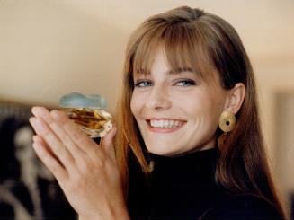Mega-model Paulina Porizkova gets playful with a bottle of knowing perfume
