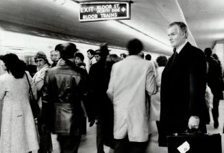 Just another rider, TTC Chairman Julian Porter watches the crowds during yesterday's morning rush hour at the Bloor-Yonge subway station. Porter, who (...)