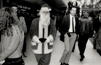 Heave ho-ho-ho, Unauthorized Santa gets bum's rush from Eaton Centre, as security guard looks on innocently