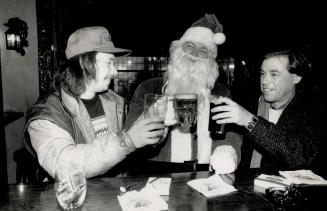 Christmas cheer, Father Christmas lifts a pint with brewski buddies Scott Burton, left, and Randy Lasenby