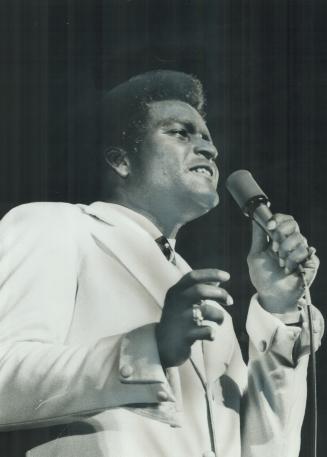 White-suited Charley Pride last night was an island of sincerity in a sea of corn at the CNE country and western show, says Star staff writer Doug Fea(...)