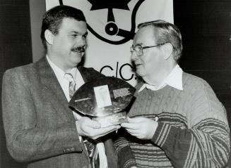Hall honoree, Star columnist Jim Proudfoot, right, is congratulated by Football Reporters of Canada president Cam Cole after his induction to FRC Hall of Fame