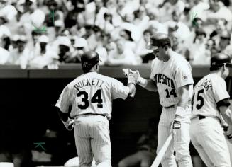 Well done, Kirby, Kirby Puckett is welcomed home by Kent Hrbek after the Twins outfielder smacked one of his two homers against the Jays yesterday