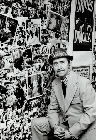 Harry Purvis, super movie buff standing in front pictures and a poster of stills from old movies