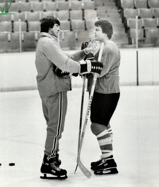 Quinn checks a cut on chin of left winger Bill Barber