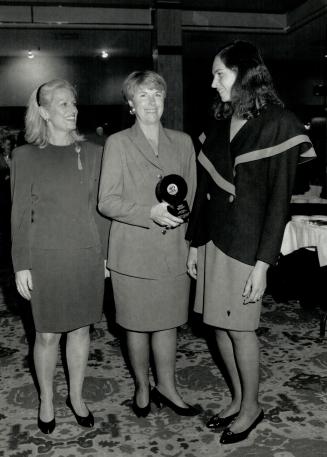 below, is congratulated by Arlene Perly Rae, is wool crepe suit by Sunny Choi
