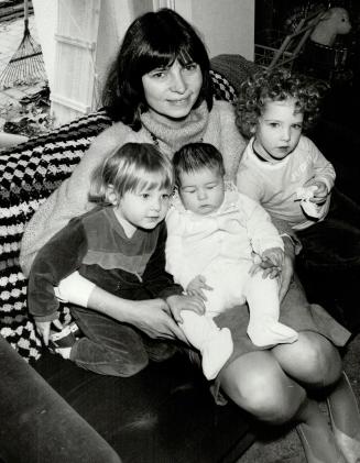 Wife of Ontario NDP leader Bob Rae, Arlene Perly Rae copes handily with three children, from left, Lisa, 2, Eleanor, 5 months, and Judith, 3, and is a tireless campaigner