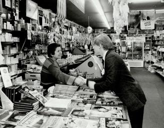 The candidate shook hands with a shopkeeper in the Pape-Danforth Aves