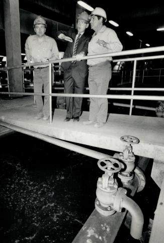 Dangerous job, NDP leader Bob Rae is flanked by workers Ron Cook (left) and Tom Elso during tour of sewage treatment plant at Ashbridges Bay yesterday, where workers suffer health problems