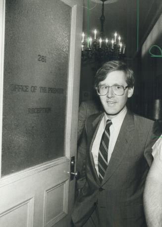 Man in the middle, NDP leader Bob Rae walks out of Premier Frank Miller's office at Queen's Park today after hearing a personal plea to support the mi(...)