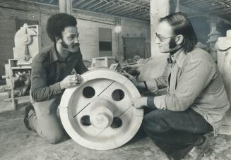 Toronto Argonaut Dave Raimey, left, and Harold Weisfeld examine a wooden mould in their refinishing shop they call Mould-Tique. Weisfeld tracks down t(...)
