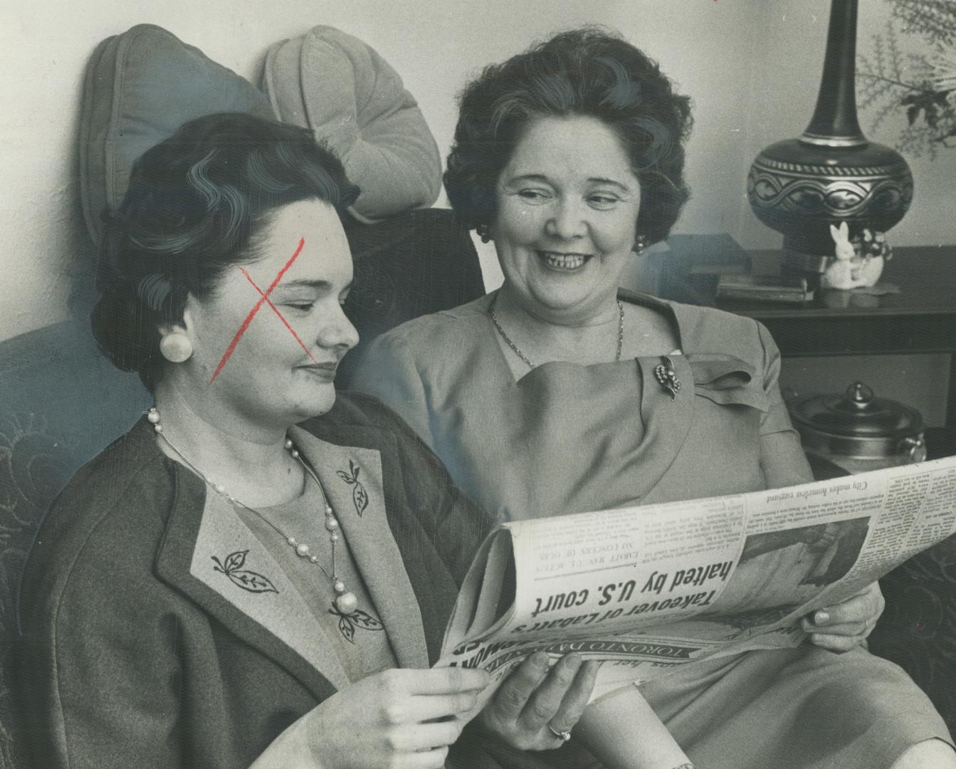 Hero's window, Mrs. Edmund Tong, right, and daughter, Margaret, excitedly read news in The Star that Queen's Park has voted to restore her full $2,750(...)