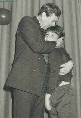Emotional victory: York Mayor Alan Tonks, in an outpouring of sentiment following his re-election last night, hugs son Christopher, 8, at the victory celebration