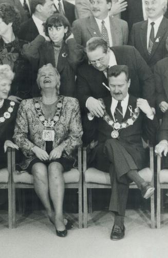 Chains of office: Alan Tonks gets some help to begin another term as Metro chairman, while Toronto Mayor June Rowlands laughs with her seatmate