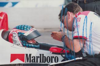 Tracy pit stop: West Hill's Paul Tracy, who will start today's race in the second row, consults with pit crew member