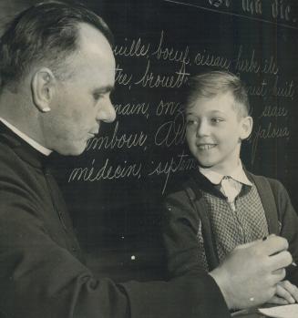 Ten-year-old son of Acting-Major Paul Triquet, Victoria Cross winner, Claude, is a pupil at Sacred Heart school at Cabano, Que. Here he smiles confide(...)