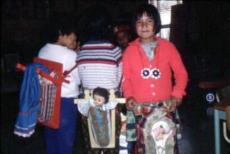 Young Indigenous girls with dolls in cradle-boards.