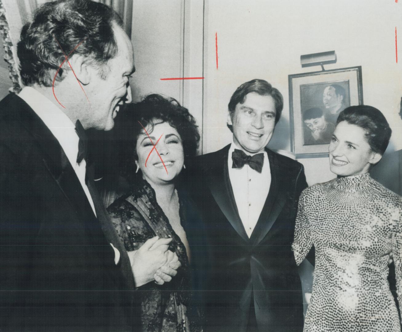 Dazzling in a skintight sequinned dress, Margaret Trudeau chats with John Warner, husband of actress Elizabeth Taylor, during reception last night at Canadian Embassy in Washington