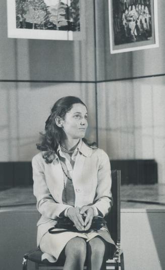 Sedate image is presented by Mrs. Pierre Trudeau, her hands in her lap, wearing a demure two-piece off-white suit as she appears at a press conference(...)