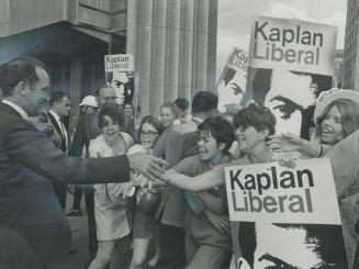 Straining to touch him, eager girls greet Prime Minister Pierre Elliott Trudeau at City Hall yesterday