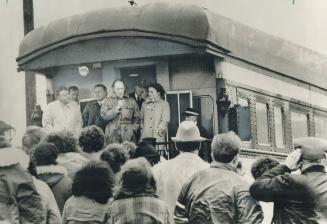 On a private train, Prime Minister Pierre Trudeau and his wife, Margaret, greet a crowd along the tracks yesteday in Iona, N.S. Last night Trudeau was(...)