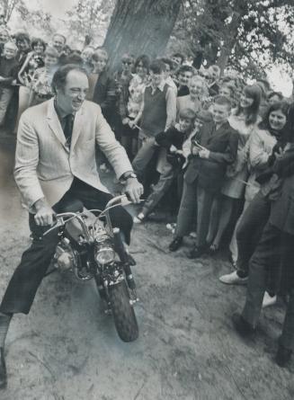 Taking an unscheduled ride, Prime Minister Pierre Trudeau tries out out aminibike yesterday during his visit to Strathroy, one of 10 Ontario towns he (...)