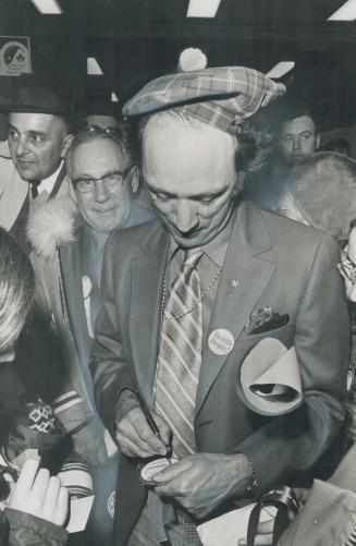 Sporting a new tam, Prime Minister Pierre Trudeau wears hat that girl gave him when he visited athletes training at Olympic Village, near Saskatoon