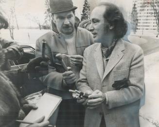 Papa Prime Minister Pierre Trudeau passes out cigars to newsmen waiting outside of Civic Hospital in Ottawa as he arrives to visit his 23-year-old wif(...)