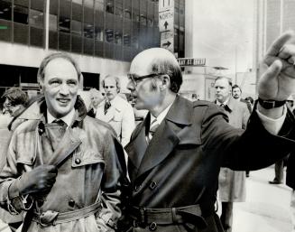 A cheerful Prime Minister Pierre Trudeau is given some pointers by Scarborough Mayor Paul Cosgrove-a Liberal candidate in the upcoming federal electio(...)