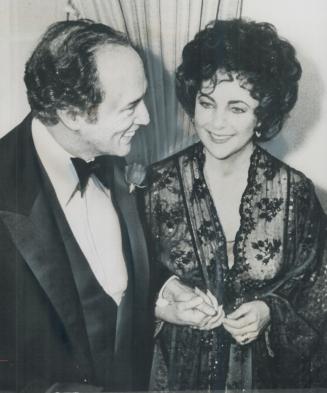 Their hands clasped, Prime Minister Pierre Trudeau and actress Elizabeth Taylor chat during reception last night at Canadian Embassy in Washington. She attended with new husband, John warner