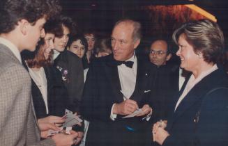 Former prime minister Pierre Trudeau signs autographs for admirers at O'Keefe Centre last night at the opening of Macbeth