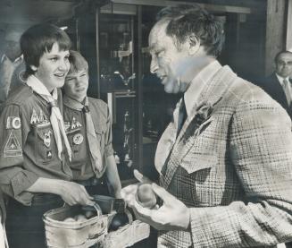 Prime Minister Pierre Trudeau got a free apple from Boy Scouts Al Saplys, left, and Simon Namikas