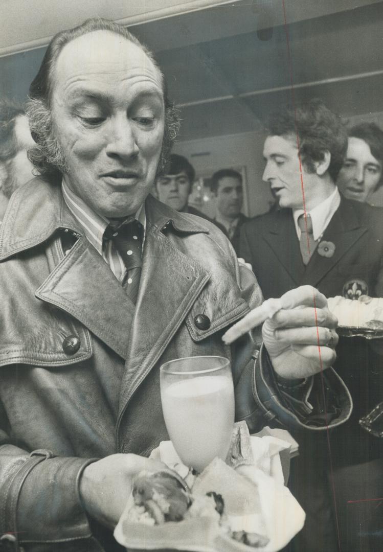 Prime Minister Pierre Trudeau has a bite to eat on the ferry between Levis and Quebec city