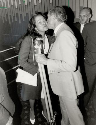 Top form: Former Prime Minister Pierre Trudeau, holding two paddles presented as a gift, greets Marina Acosti-Izzi, an American delegate to Metro computer conference, which ends tomorrow