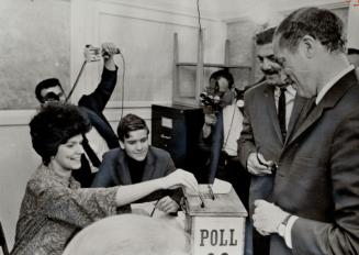 Prime Minister voting: Deputy returning office Jean Riley prepares to place Pierre Elliott Trudeau's ballot in the ballot box