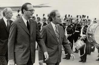 Jacques Chirac, French Premier and Canadian Prime minister Pierre Trudeau, passing in front of honor guard at Orly airfield upon arrival of Canadian Premier this morning