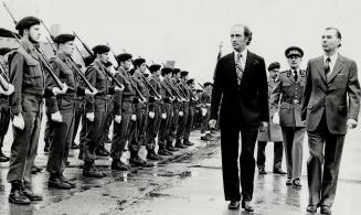 Brussels: Canadian Prime Minister Pierre Trudeau with Belgian Prime Minister Leo Tindemans review the honor guard during welcoming ceremonies at Zaventum airport in Brussels