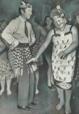 Prime Minister Pierre Trudeau wears a traditional Maori skirt and tries an ancient dance, new to him, with a Maori woman in other traditional garb. Tr(...)