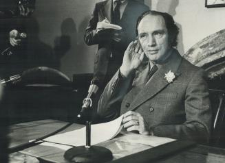 Prime Minister Pierre Trudeau listens to a question at the news conference at which he announced his cabinet changes
