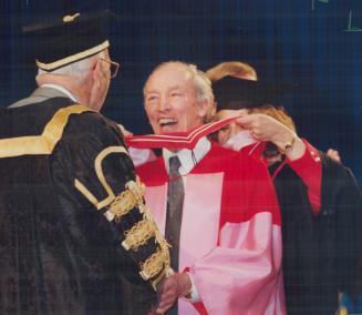 Degree of honor: Former Prime Minister Pierre Trudeau laughs with University of Toronto Chancellor John Black Aird yesterday as he receives honorary doctorate of laws