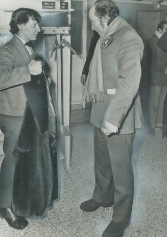 Ready for the North: Prime Minister Pierre Trudeau is helped to bundle up in a heavy coat by a Cambrian College student after a town hall meeting in Sault Ste. Marie