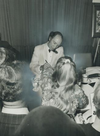A kiss declined by Prime Minister Pierre Trudeau, as he saw photographers hovering near him at the Canadian Manufacturers' Association dinner last nig(...)