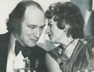 Prime Minister Pierre Trudeau listens intently to sari-clad Mrs