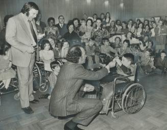 Prime Minister Pierre Trudeau chats with 5-year-old Luigi Perruzza at the Ontario Crippled Children's Centre on Rumsey Road today when he visited to centre to launch the 1972 Easter Seals campaign