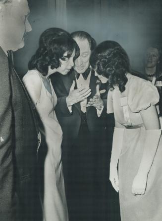 Two young women listen carefully to Prime Minister Pierre Trudeau after the $50-a-plate dinner at the Royal York Hotel he addressed last night, which (...)