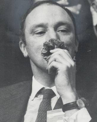 Scenting victory, Pierre Elliott Trudeau sniffed at a carnation tossed to him by an admirer while he waited announcement of balloting results at convention