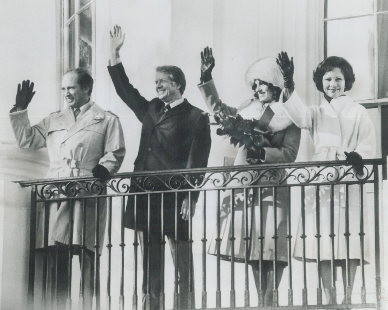 Prime Minister Pierre Trudeau and President Jimmy Carter, with their wives, Margaret and Rosalynn, wave yesterday from a balcony of the White House